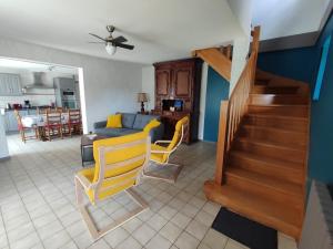 a living room with a couch and a table at Gîte L'épinette in Grozon