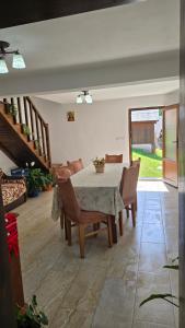a dining room with a table and some chairs at Casa Bogdan in Bubesti 