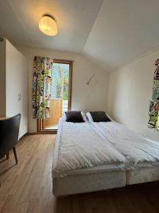 a bedroom with a large bed and a window at Hellesylt Hostel in Hellesylt