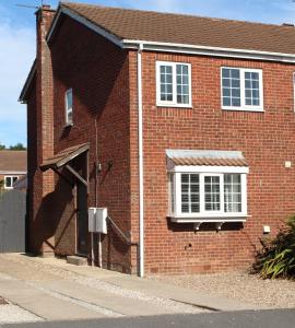 a red brick building with a white window at Fabric View in Holmewood