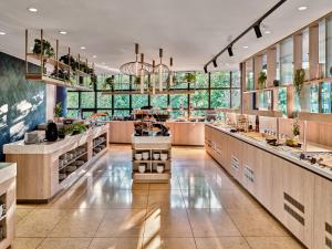 a large kitchen with counters and a large window at Crowne Plaza Bratislava by IHG in Bratislava
