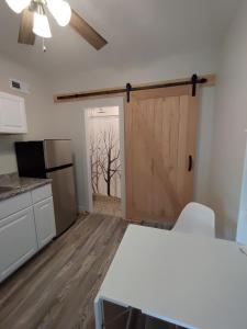 a kitchen with a sliding door and a refrigerator at Neville Island Motel in Pittsburgh