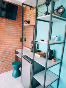 a room with white shelves and a brick wall at HOLLYWOOD Skiathos in Skiathos +106 photos