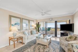 a living room with a couch and a tv at Amelia Surf and Racquet Club Condo - Ocean View - 2nd Floor - Pools - Tennis Courts - Sleeps 8 in Fernandina Beach