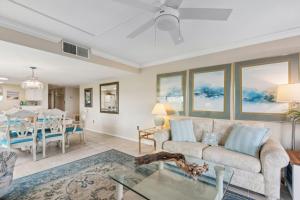 a living room with a couch and a dining room at Amelia Surf and Racquet Club Condo - Ocean View - 2nd Floor - Pools - Tennis Courts - Sleeps 8 in Fernandina Beach