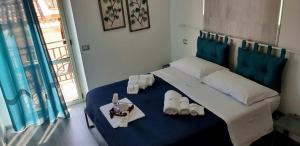 a bedroom with a large bed with shoes on it at B&B Da Me in Crotone