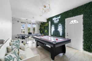 a room with a pool table and ping pong balls at 4BR Hollywood Villa 3 min to Beach, Heated 12-Person Jacuzzi, Game Room and BBQ in Hollywood