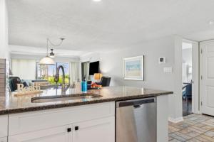 a kitchen with a sink and a living room at Amelia Surf and Racquet Club Condo - 1st Floor Ocean View - Pools - Tennis Courts - Sleeps 4 in Fernandina Beach +18 photos