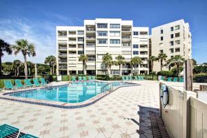 a swimming pool in front of a apartment building at Amelia Surf and Racquet Club Condo - 1st Floor Ocean View - Pools - Tennis Courts - Sleeps 4 in Fernandina Beach