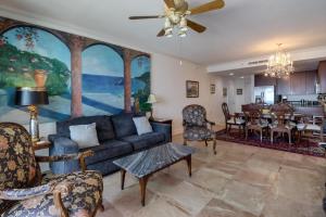 a living room with a couch and a dining room at Capri On The Biloxi Coast in Biloxi
