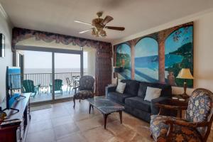 a living room with a couch and a view of the ocean at Capri On The Biloxi Coast in Biloxi