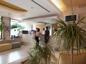a group of people shaking hands in a lobby at Interpass Vau Hotel Apartamentos in Portimão +74 photos