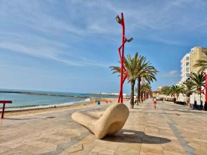 a sculpture on a beach next to the ocean at Casa caloret -Playa y centro a 2 min - 1ªPlanta in Vinarós