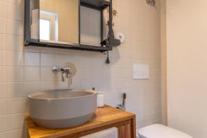 a bathroom with a tub sink and a toilet at SUNNY PATIO Flat in Lisbon +12 photos