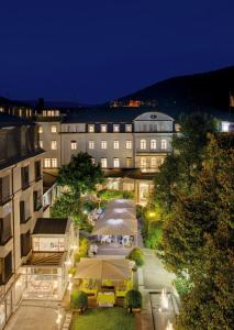 a view of a building with a courtyard at night at Hotel Europäischer Hof Heidelberg in Heidelberg
