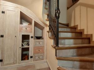 a staircase with a wooden cabinet next to a stair case at La Cabaña in Mozoncillo de Juarros