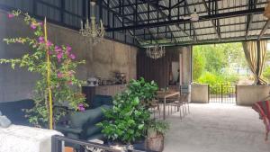 a living room with a couch and some plants at Buknari in Buknari