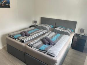 two beds with pillows on them in a bedroom at Eastside - Apartment WHG 02 in Senftenberg