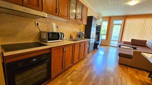 a kitchen with a microwave and a stove top oven at Green House Apartment in Burgas City