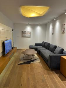 a living room with a couch and a table at Venus Luxury Apartment in Skopje