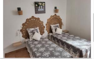 two beds sitting next to each other in a room at Résidence la Citadelle in Saint-Florent