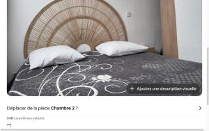 a picture of a bed with two pillows at Résidence la Citadelle in Saint-Florent