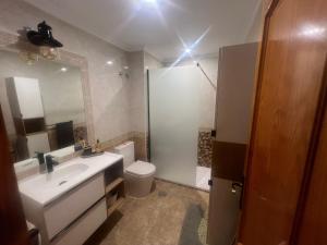 a bathroom with a sink and a toilet and a mirror at Playamarina 2 Cabo Roig in Playas de Orihuela +11 photos