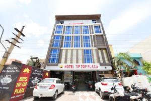 a building with cars parked in front of it at Collection O Tip Top in Jaipur