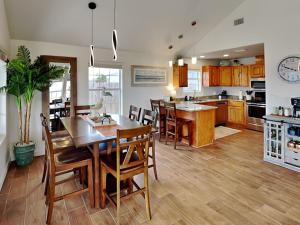 a kitchen and dining room with a table and chairs at Inn at Dolphin Bay in Rockport
