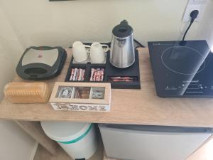 a wooden counter with a coffee maker on top of a toilet at Ionian Boutique Apartments - Corfu Seaside Getaways in Agios Georgios