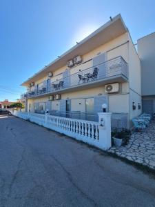 a building with balconies on the side of a street at Ionian Boutique Apartments - Corfu Seaside Getaways in Agios Georgios +7 photos