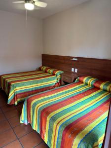Postel nebo postele na pokoji v ubytování Hotel Posada del Rosario