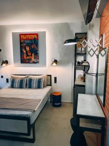 a bedroom with a bed and a poster on the wall at HOLLYWOOD Skiathos in Skiathos