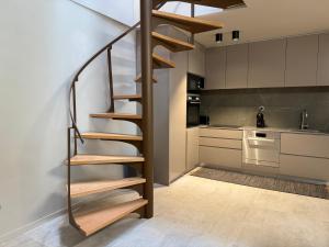 a spiral staircase in a kitchen next to a kitchen at Cantinho da Cuca - Gerês in Terras de Bouro