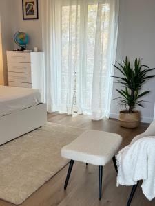a bedroom with a bed and a chair and a window at La Terrazza Sulla Valle in Sgurgola
