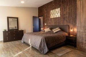 a bedroom with a large bed and a mirror at 701 Stunning Views PH private terrace apt Rooftop in Mexico City