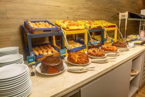 a buffet filled with lots of food on a table at Golden Tulip Natal Ponta Negra in Natal