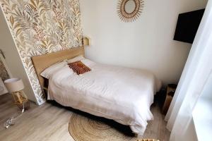 Ένα ή περισσότερα κρεβάτια σε δωμάτιο στο L'escape Rue Calme - Free parking