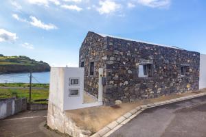 a stone building with a door on the side of it at Casa Mare in Lagoa