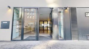 an entrance to a building with glass doors at chambre avec salle de bain privée au cœur de La Défense in Nanterre