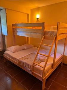 two bunk beds in a room with a yellow wall at Casa da Forja - Gerês in Gondoriz +17 photos