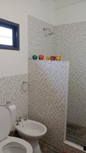 a bathroom with a toilet and a sink and a shower at Aire de lavandas in La Paz +10 photos