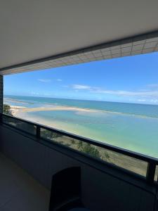 a room with a view of the ocean at Flat beira mar Olinda Empresarial Jam in Olinda
