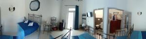 a room with a blue bed and a doorway at Zia Maria in Bari