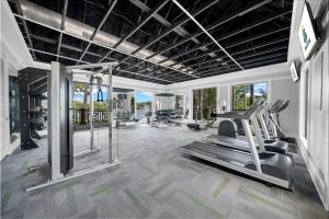 a gym with treadmills and elliptical machines at Vibrant 2br Apt Pool, Jacuzzi, Gym #11 in Tampa