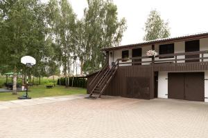 a house with a staircase on the side of it at Viesu nams Pupa in Kuldīga