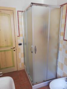 a shower with a glass door in a bathroom at La Bouganville in Macerata