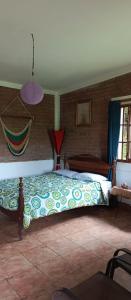 a bedroom with a bed and a hammock at Finca Eco Turística Aguas del Arenal 