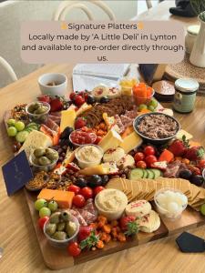 a platter of different types of food on a table at Watersmeet Edge, Terrace, 2BR and 2BA, River Views, Parking in Lynmouth