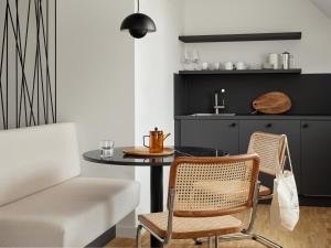 a dining room with a table and two chairs at Bob W Munich Schwabing in Munich